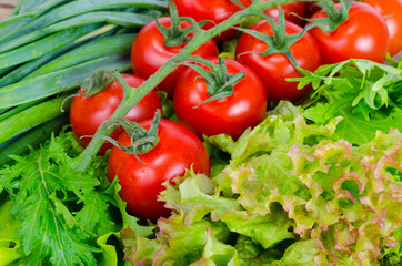 Vegetable background, lettuce, tomatoes and green onions.