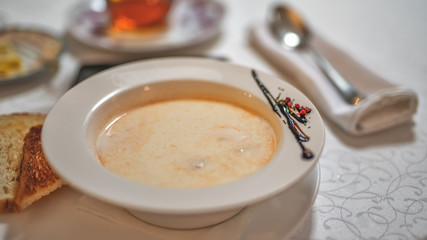 a plate of fish cream soup on the table