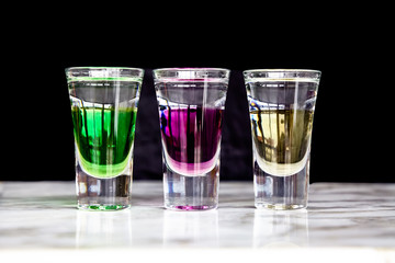 Shots with three different liqueurs: Apple, berries, vanilla.