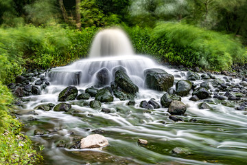 Obraz premium mixing zone of sewage discharge of urban sewage. river pollution. city dumps. long exposure