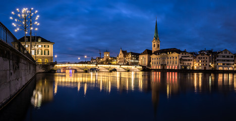 Fototapeta na wymiar Zurich, Switzerland - view of the old town with the Limmat river and the Fraumunster church - panoramic image of very high resolution