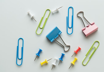 colorful metallic clamps and paper clips on white background