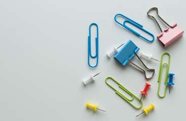 colorful metallic clamps and paper clips on white background