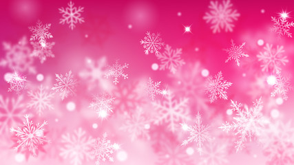 Christmas blurred background of complex defocused big and small falling snowflakes in pink colors with bokeh effect