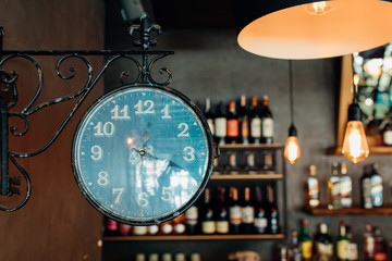 Old wall clock and Vintage luxury interior lighting decor at Restaurant, cafe or bar. old Vintage light bulb lamps. Restaurant Bar or Cafe interior design.  - Powered by Adobe