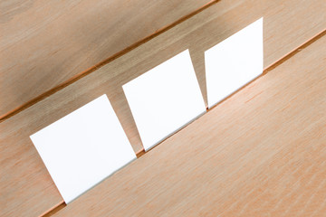 Blank portrait mock-up paper. brochure magazine isolated on brown wooden table, changeable background / white paper isolated on wood