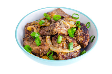 Fried liver with onions in bowl on white background.