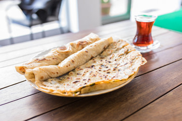 Traditional Turkish pastry breakfast food Borek or Burek with Turkish Tea. Traditional Turkish food culture or cuisine.