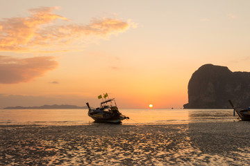 Long tail boat on Pak Meng beach, Trang province, Thailand at sunset