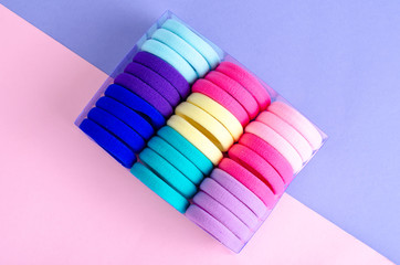 Colored hair ties on bright background. Photo