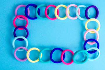 Obraz premium Colored hair ties on bright background. Photo