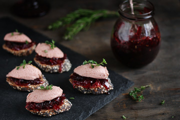 Canapes snacks with chicken pate and onion marmalade (chutney)