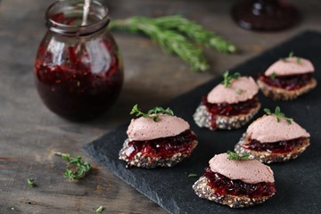 Canapes snacks with chicken pate and onion marmalade (chutney)