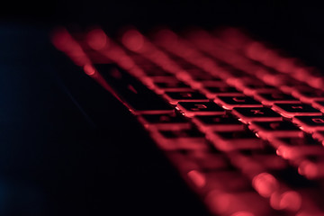 Computer keyboard red backlit in the dark