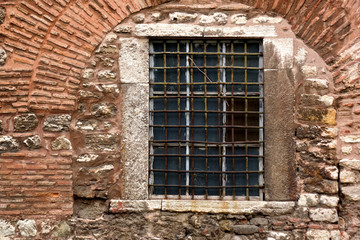 Fototapeta na wymiar close up window of old brick building exterior of Hagia Sophia cathedral in Istanbul, Turkey