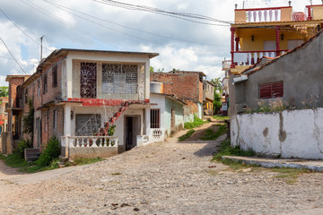 Fototapeta na wymiar Residential neighborhood in a small Cuban Town during a cloudy and sunny day. Taken in Trinidad, Cuba.