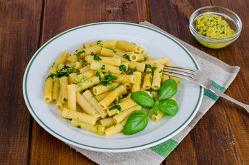 Penne pasta with pesto sauce. Italian cuisine. 