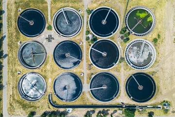 Modern wastewater treatment plant, top view from drone, sedimentation tanks round form