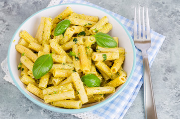 Italian pasta with pesto sauce and basil leaf