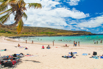 Anakena Beach on Easter Island, featuring tranquil waters, iconic moai statues, and palm trees under a sunny sky, a serene and culturally rich Polynesian destination