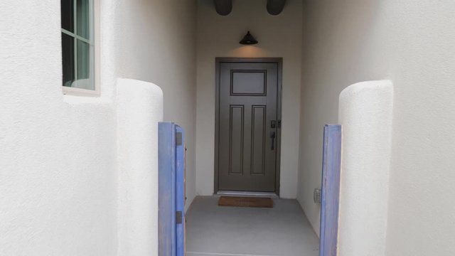 Home Exterior Move Backward from Door Entrance. view moves forward Back from the front door entrance of a southwest home in New Mexico