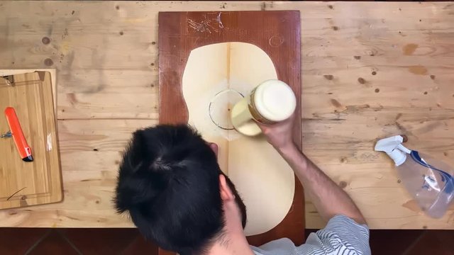 Time lapse of guitar maker glueing the acoustic guitar rosete