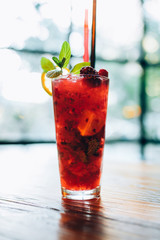 Red, fresh summer strawberry smoothie cocktail juice beverage with ice.