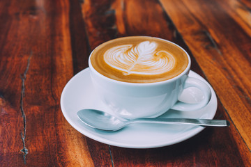 Coffee latte on wood table in coffee shop