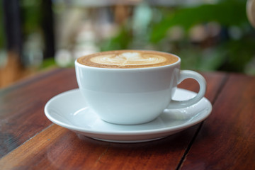 Coffee latte on wood table in coffee shop