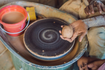 Boy doing ceramic pot in pottery workshop