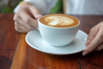 Coffee latte on wood table in coffee shop