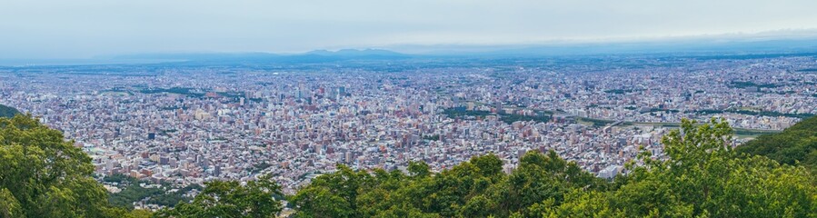 Panorama beautiful landscape view of Sapporo City from viewpoint of Mount Moiwa in cloudy day at Hokkaido, Japan.
