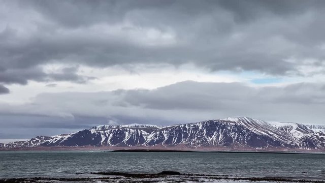 Time lapse of the Atlantic ocean and the clouds above Esja Mountain in winter near Reykjavik, Iceland.
