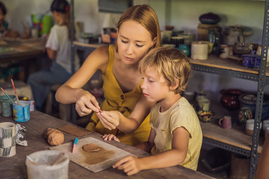 mother and son doing ceramic pot in pottery workshop