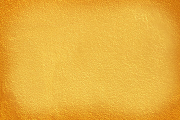 Gold paint on cement wall texture.