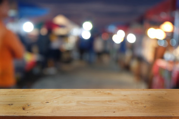 Empty dark wooden table in front of abstract blurred bokeh background of restaurant . can be used for display or montage your products.Mock up for space.