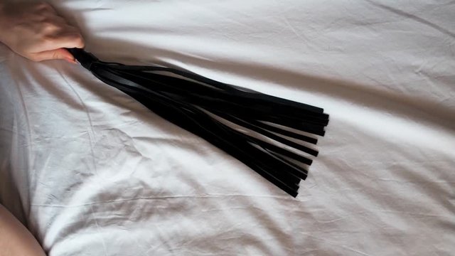 leather whip Flogger in hand girl dominatrix dominatrix for sensual sex role play