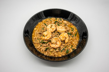 Fry pork and shrimp with basil in black ceramic dish. Pad Ka prao (Stir Fried Pork with Holy Basil).