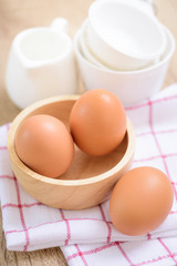 Eggs prepared for baking, placed on a wooden table