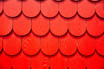 background of red wooden shingles. new textured wooden roof