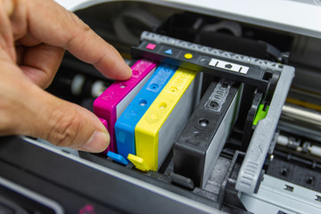 Technicians are installing the color printer inkjet cartridge