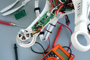 Disassembled drone quadrocopter under repair for fixing problems.