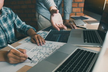 Two software developers are analyzing together about the code written into the program on the...