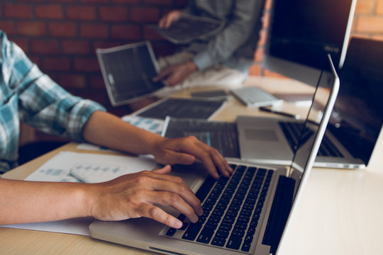 Two software developers are analyzing together about the code written into the program on the computer.