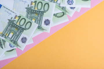 Euro cash on a yellow and pink background. Euro Money Banknotes. Euro Money. Euro bill. Place for text.