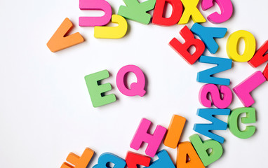 Isolated Colorful Wooden Word ' EQ '  or Emotional Quotient                               