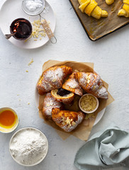 Fresh croissants with chocolate on a white background top view