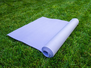 Yoga Mat, Pilates or fitness on green lawn. Training in the fresh air