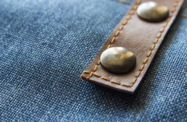 Leather label on denim clothing. Detail of Blue Jeans denim texture. The concept of Fashion jeans. 