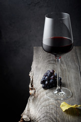 A glass of red wine close up on an old wooden table